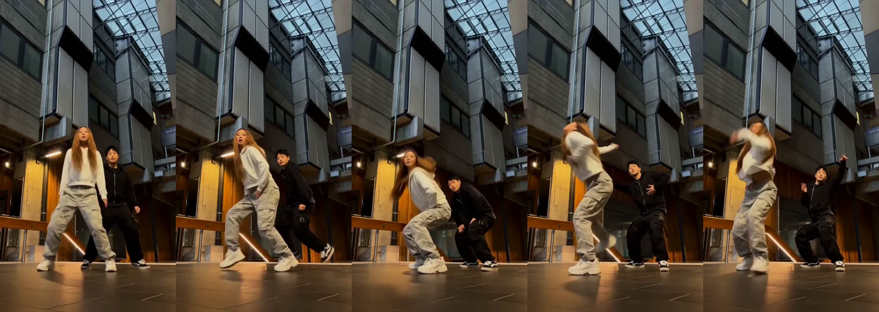 A2O LITE NEON AI dance made with Oraclip: a woman in a white hoodie and a man in a black hoodie groove side by side, sink into a bounce and finish the duo in a glass-roofed atrium