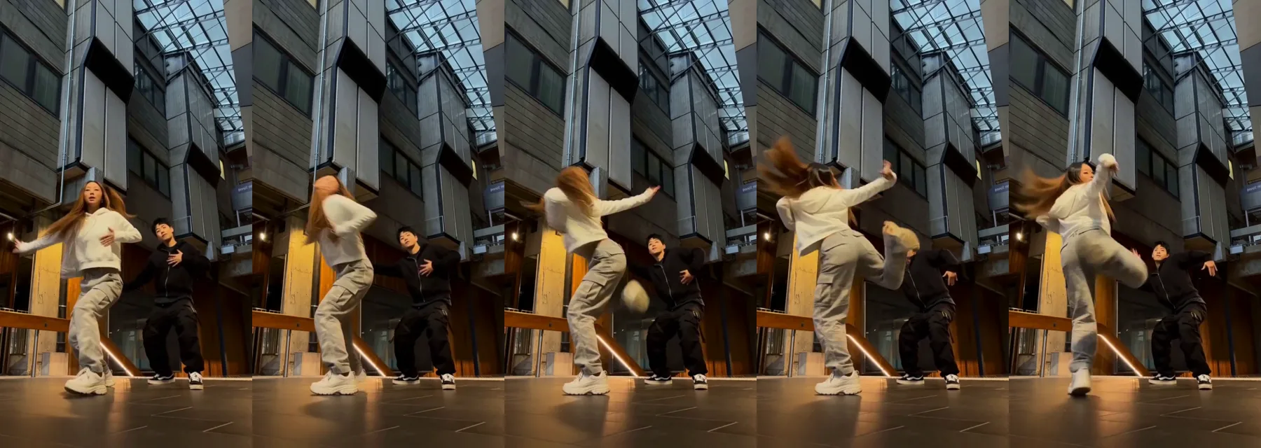The NEON spin kick, frame by frame: the dancer in the white hoodie spins, lifts her knee and snaps a high kick while her partner keeps the groove