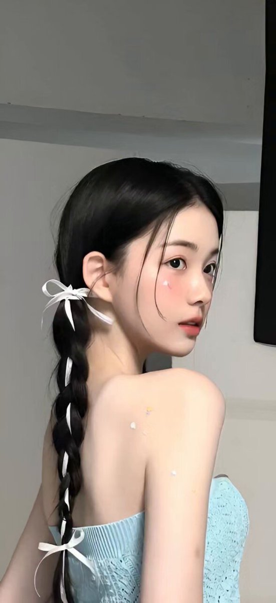 Woman with Braided Hair Turning to Camera