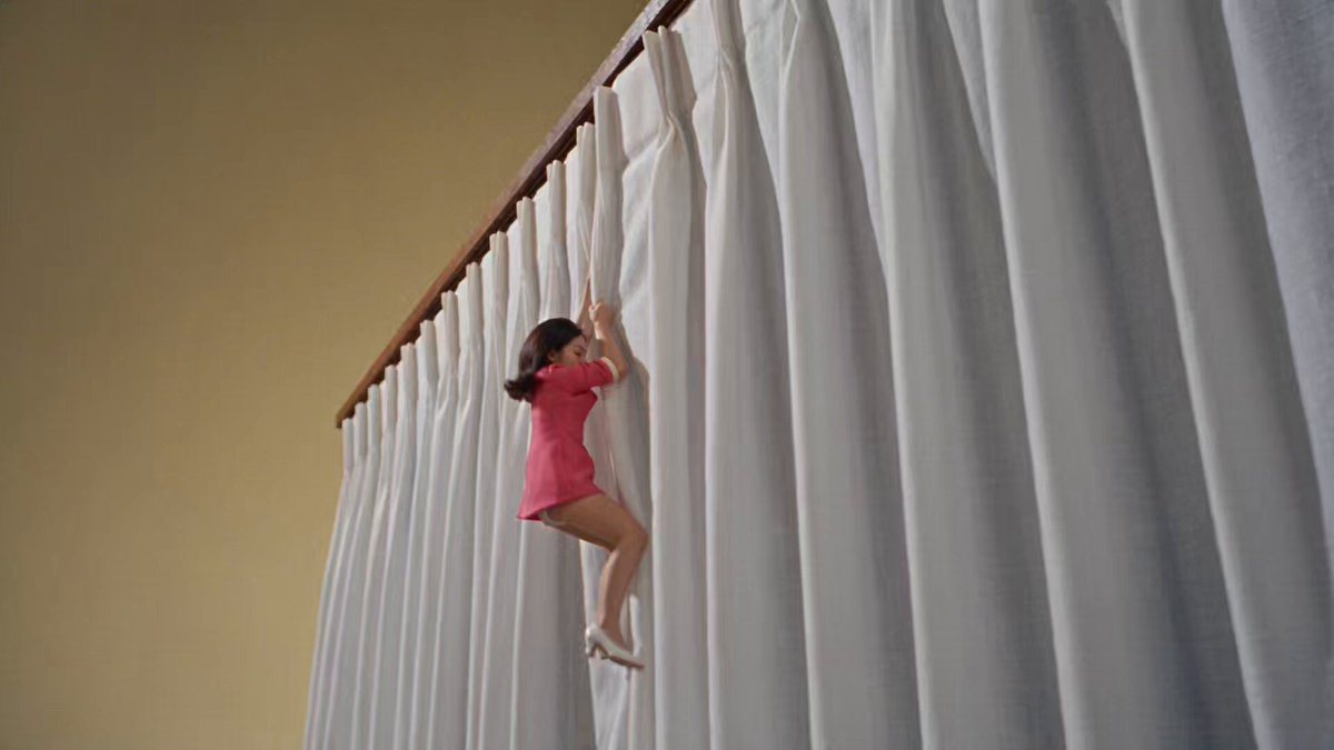 Tiny woman on giant 1960s table