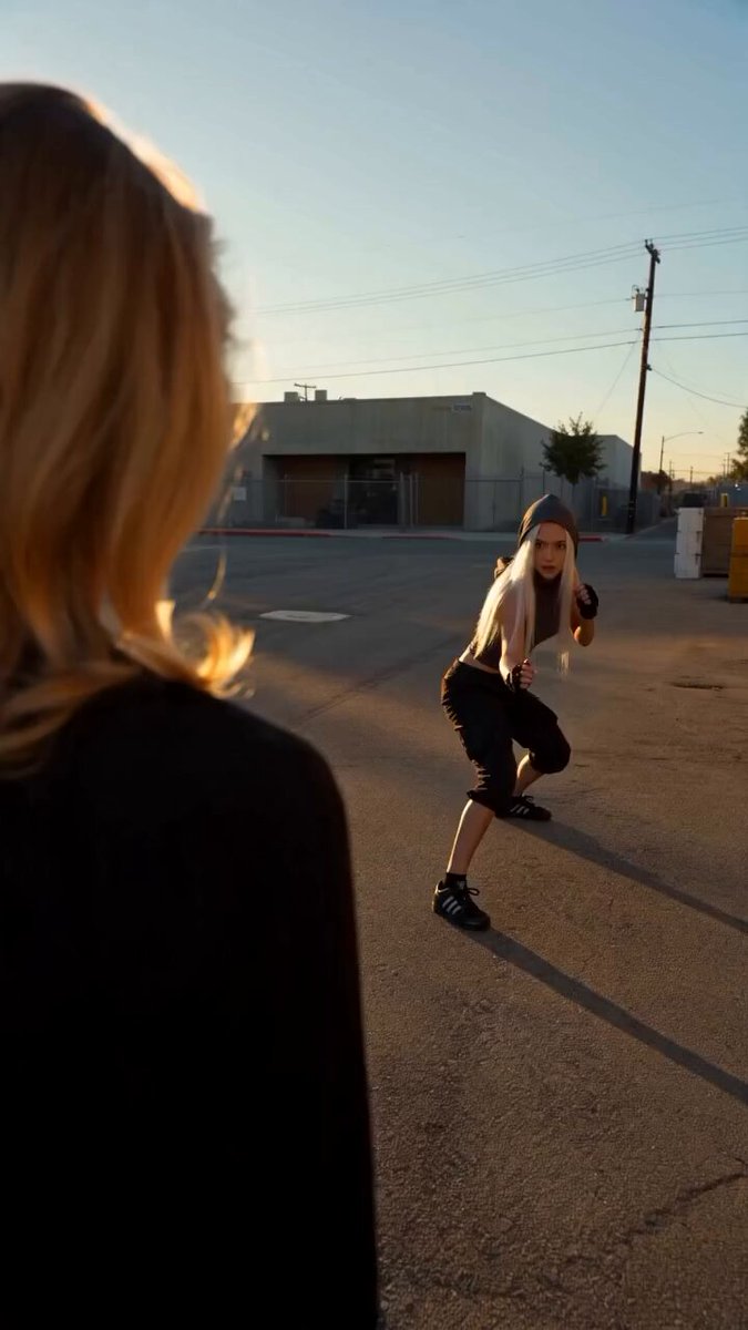 Two women fight in industrial lot