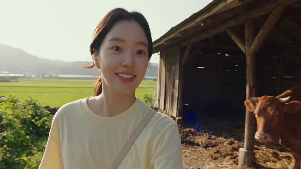 Korean woman learns to milk cow